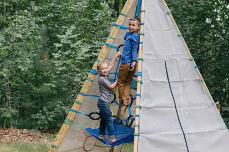 Outdoor play structure climbing area at Peak and Pine Retreat family cabin