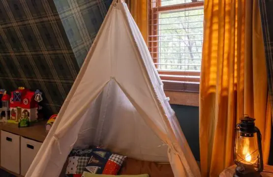 Kids tent faux campfire toys play area at Peak and Pine Retreat