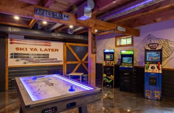 Game room entertainment area with arcade games at Peak and Pine Retreat cabin