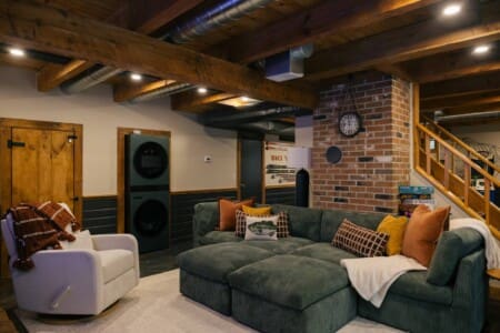 Spacious basement family room with large sectional sofa and board games at Peak and Pine Retreat