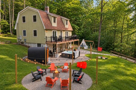 Aerial view of backyard fire pit, hot tub and sauna at Peak & Pine Retreat