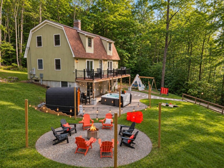 Aerial view of backyard fire pit, hot tub and sauna at Peak & Pine Retreat