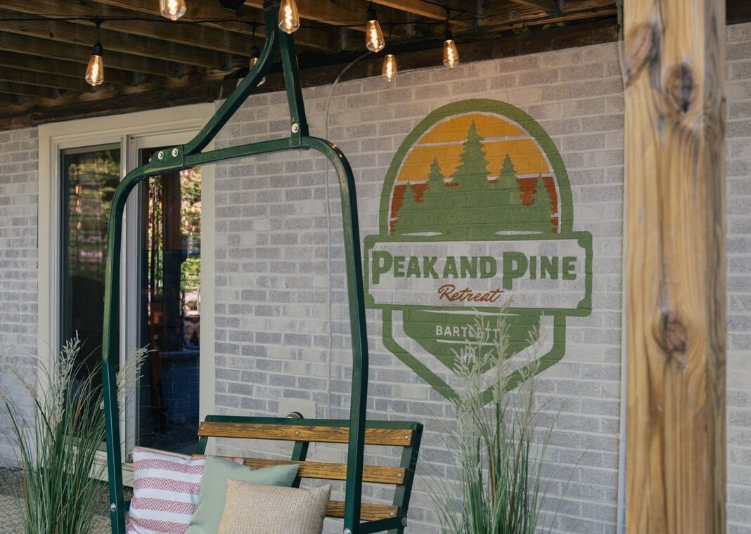 Ski chairlift swing under the deck with a Peak and Pine sign
