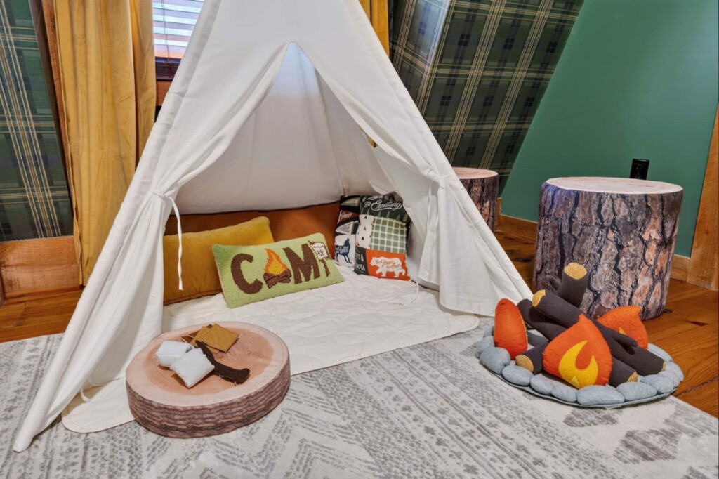 Kids play teepee with CAMP pillow and plush campfire in the bunk room