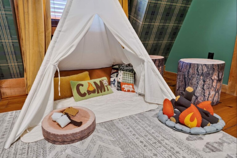 Kids play teepee with CAMP pillow and plush campfire in the bunk room