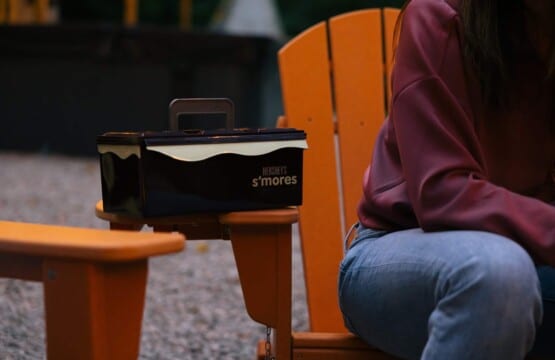 S'mores kit box on an orange Adirondack chair beside the fire pit