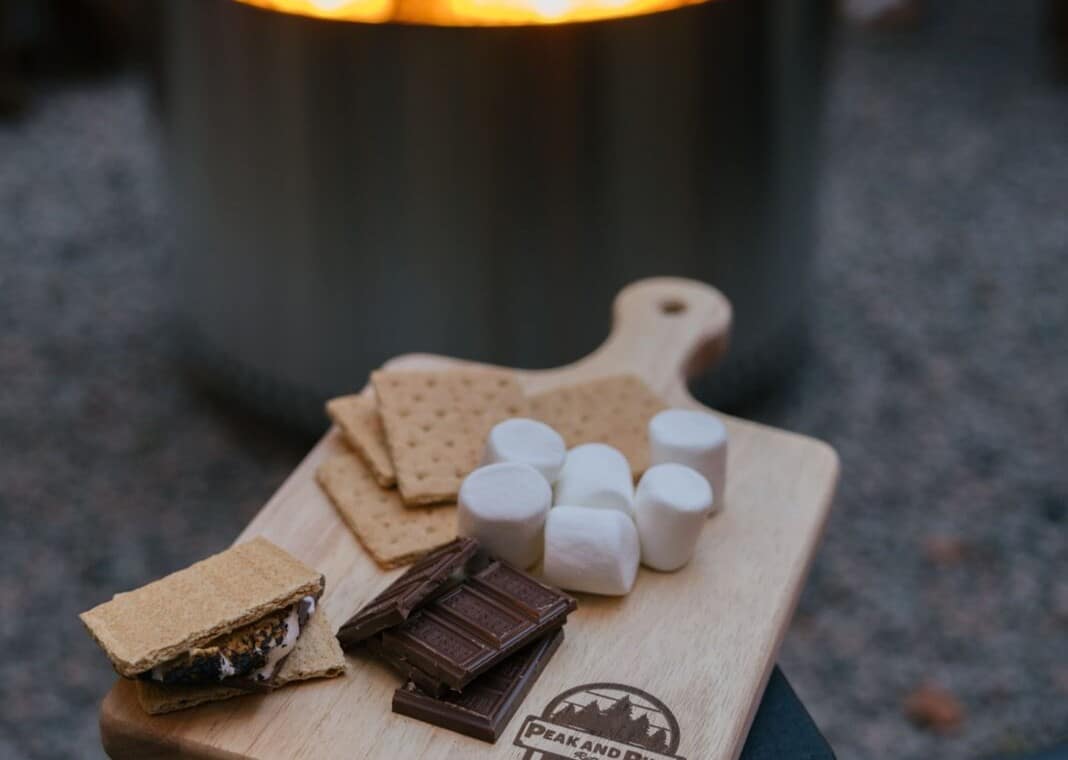 S'mores board with marshmallows, graham crackers and chocolate beside the fire pit