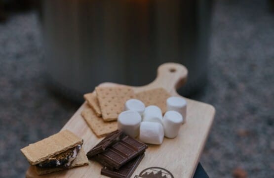 S'mores board with marshmallows, graham crackers and chocolate beside the fire pit