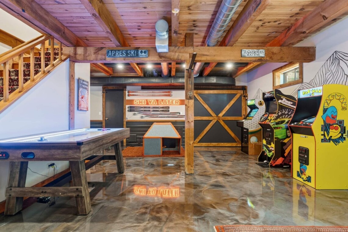 Game room with air hockey and arcade machines at Peak & Pine Retreat