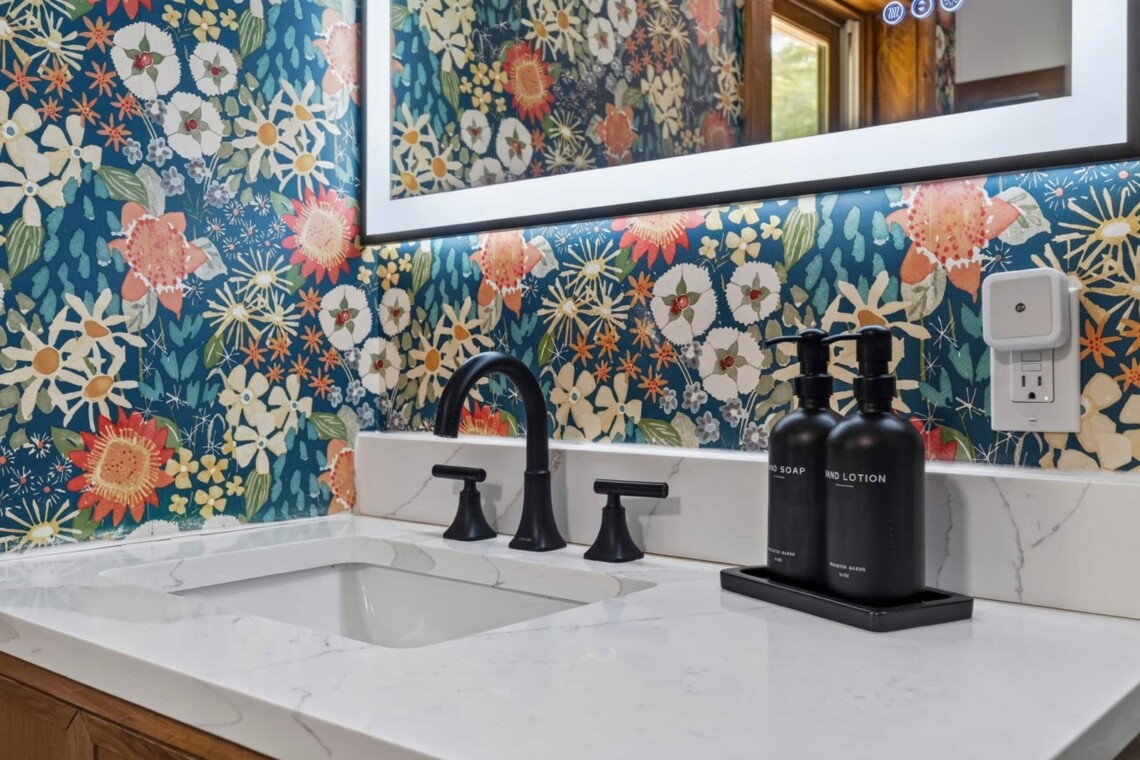 Quartz vanity sink with black fixtures and soap set at Peak & Pine Retreat