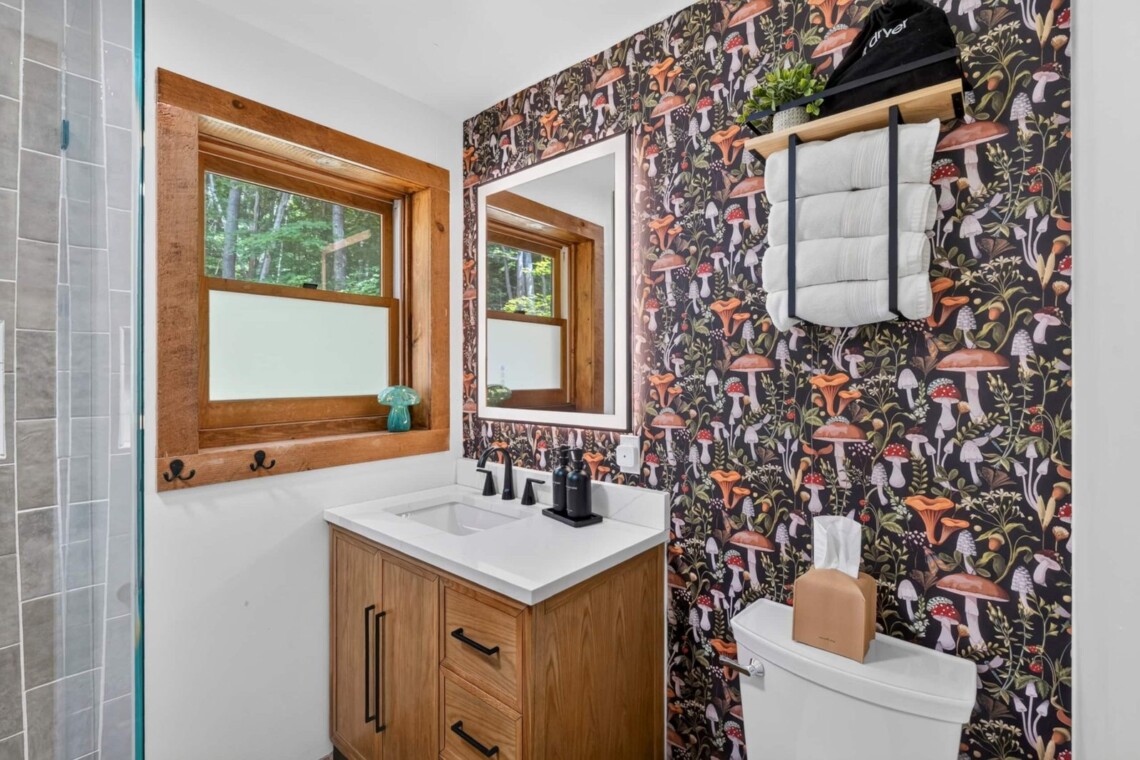 Bathroom vanity with mushroom wallpaper and towel rack at Peak & Pine Retreat