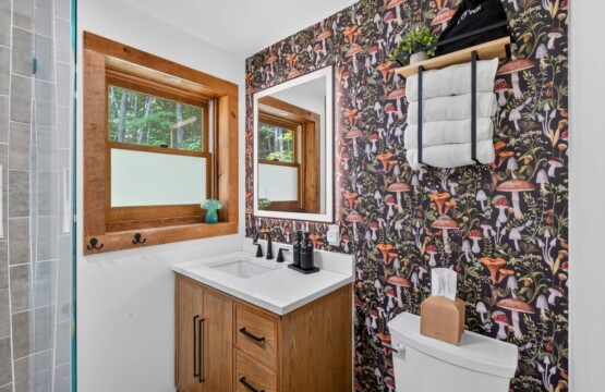 Bathroom vanity with mushroom wallpaper and towel rack at Peak & Pine Retreat