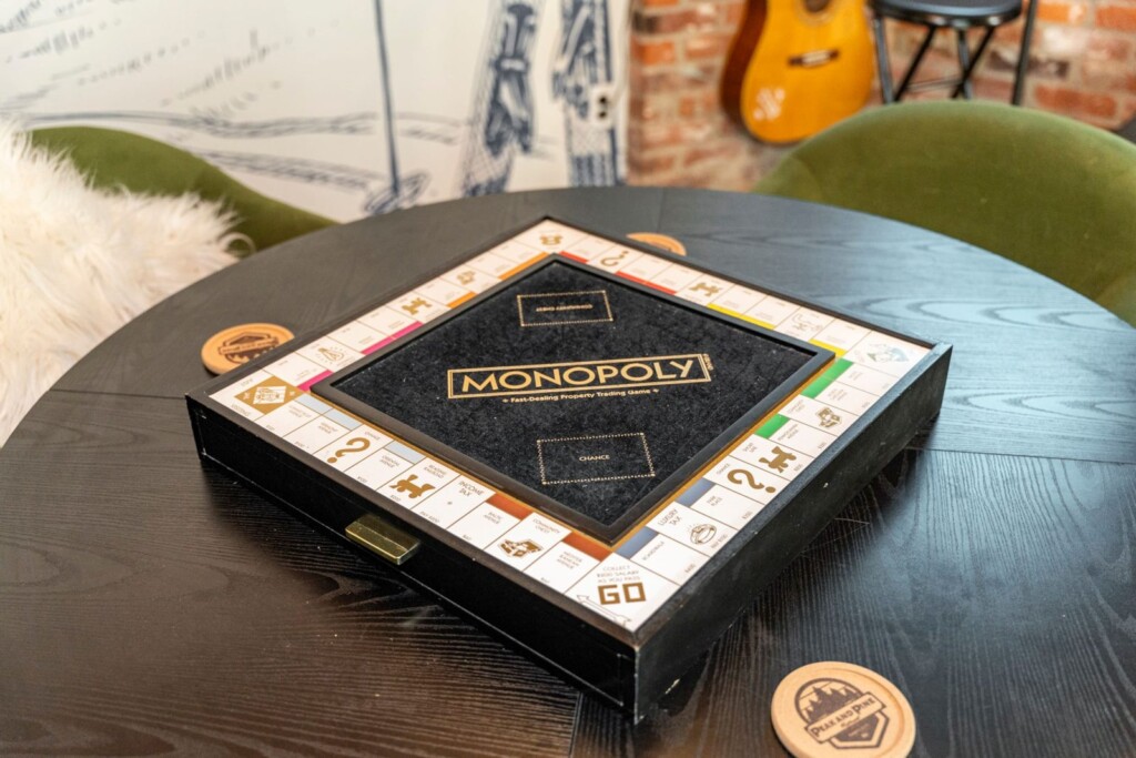 Deluxe Monopoly board game on the round game table at Peak & Pine Retreat