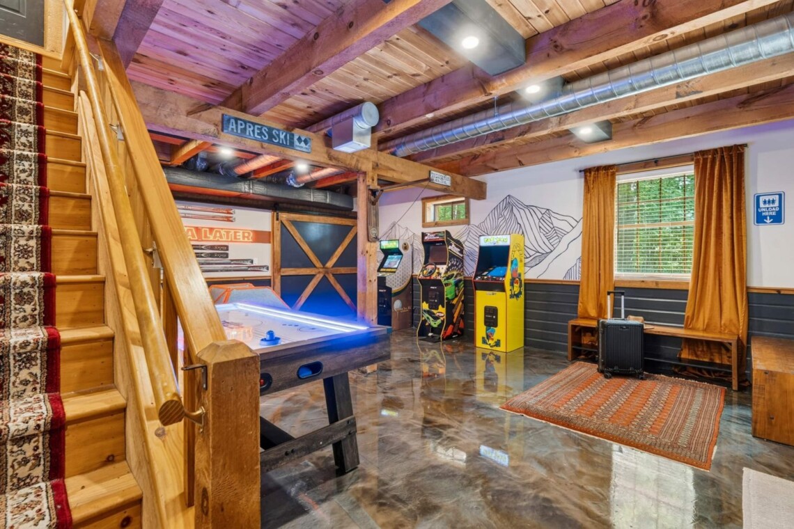 Game room seen from the stairs with air hockey and arcade machines