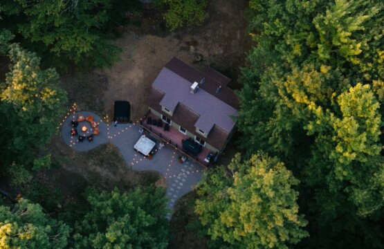 Drone view of the house tucked into dense forest near North Conway NH